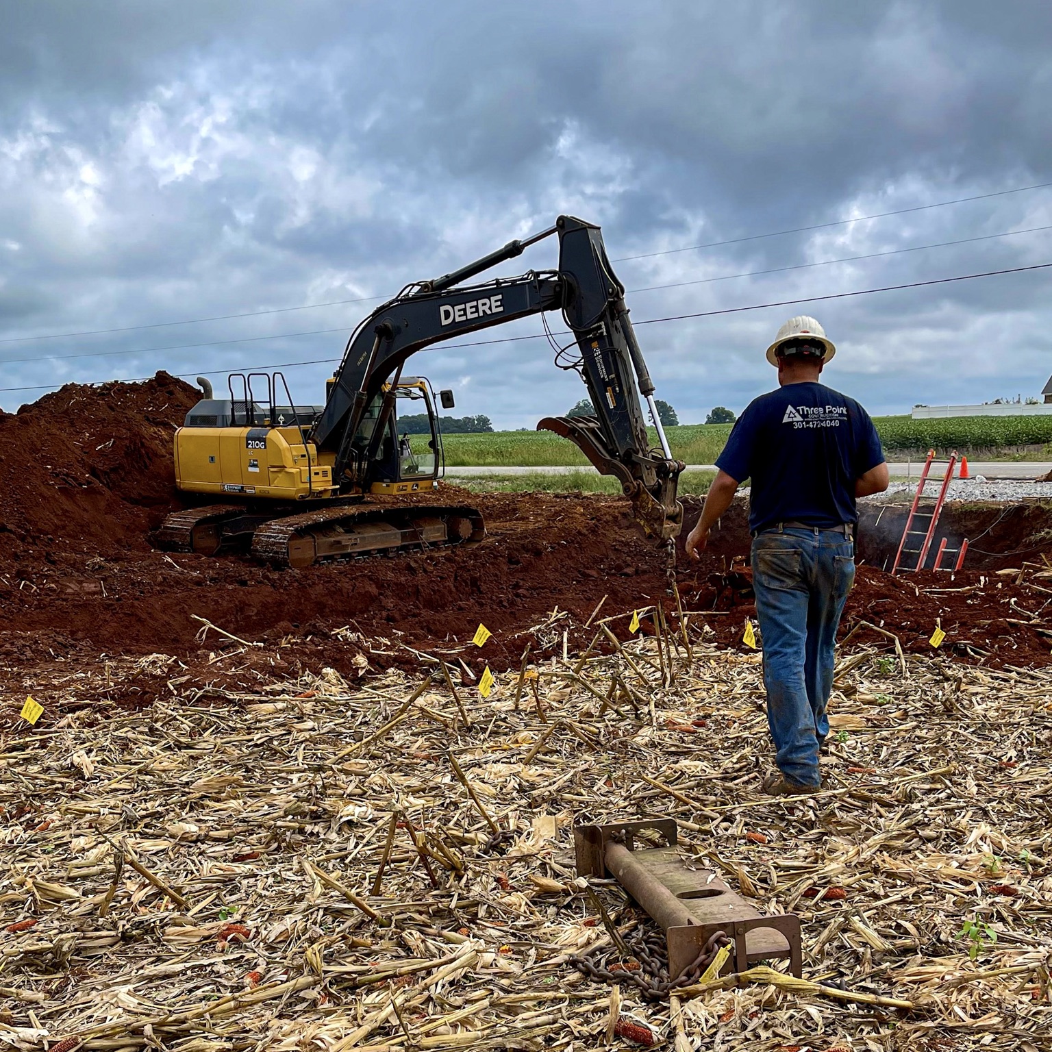 Mike Boyd standing near excavator on jobsite