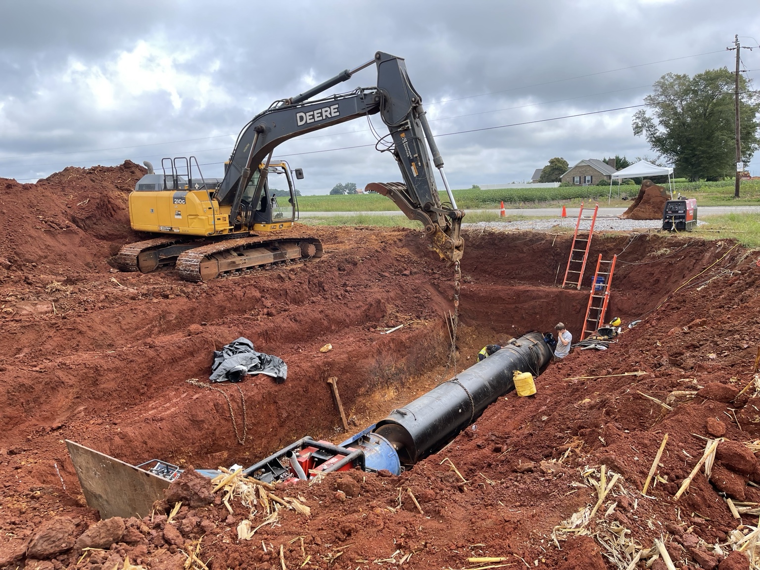 Jack and bore installation with excavator and casing